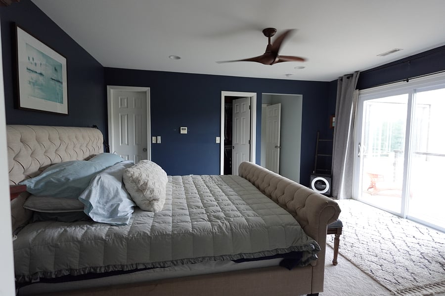 Primary bedroom with king sized bed and en suite bathroom