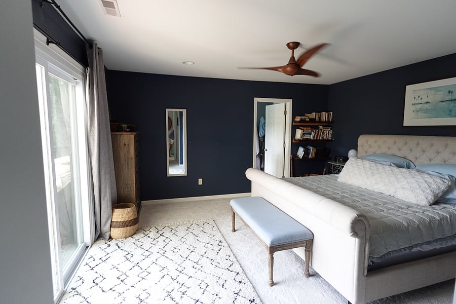 Primary bedroom with king sized bed and en suite bathroom
