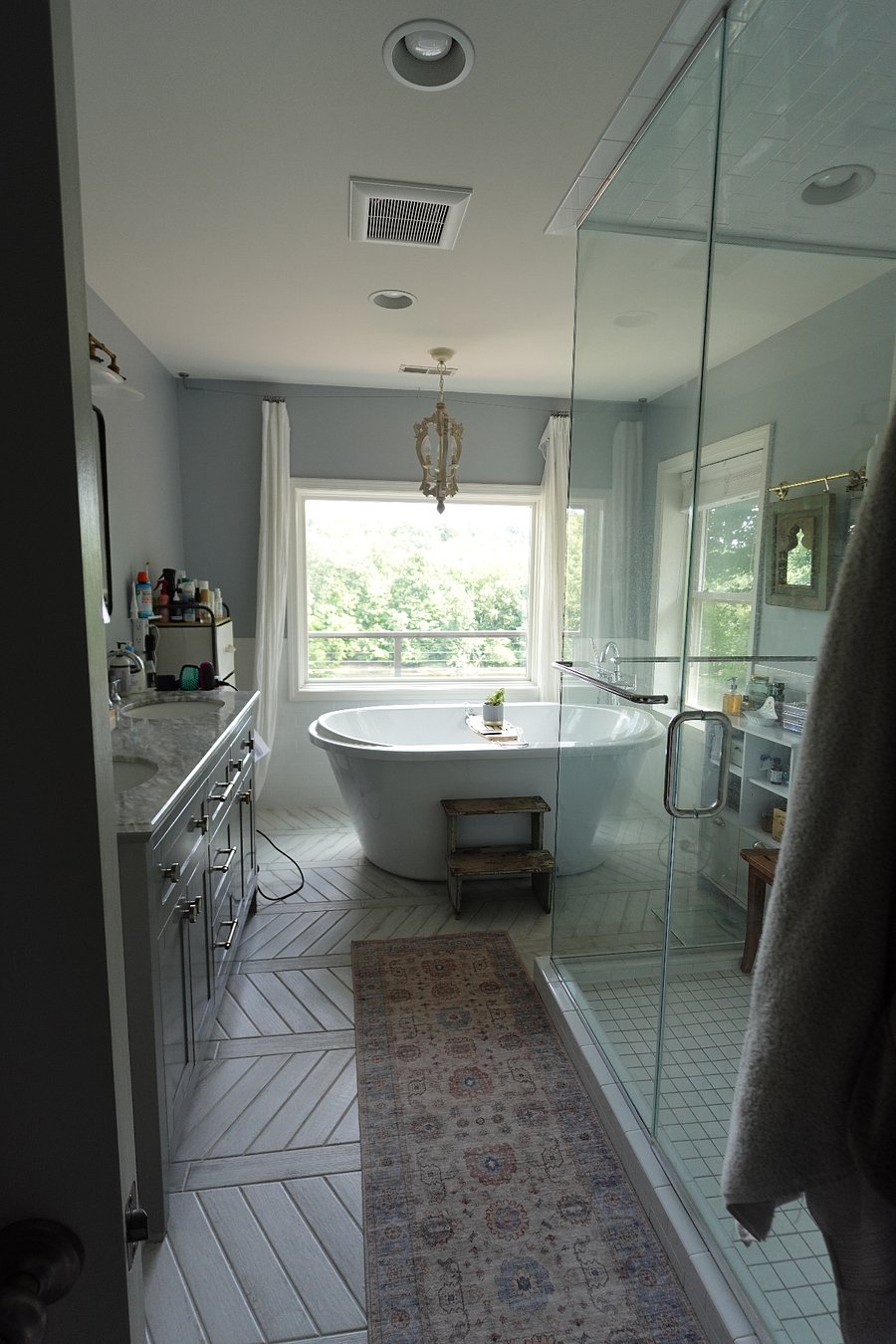 Primary en suite bathroom with walk-in shower and extra large soaking tub