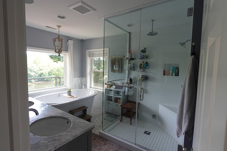 Primary en suite bathroom with walk-in shower and extra large soaking tub