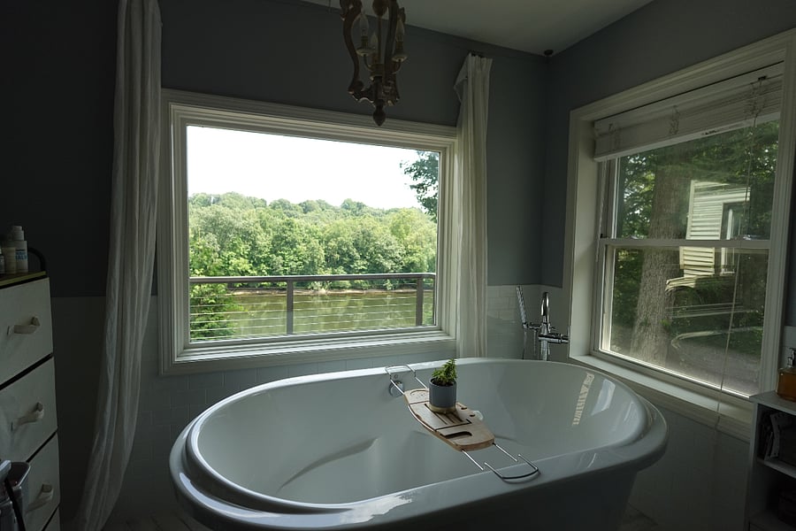 Primary bathroom soaking tub with river views