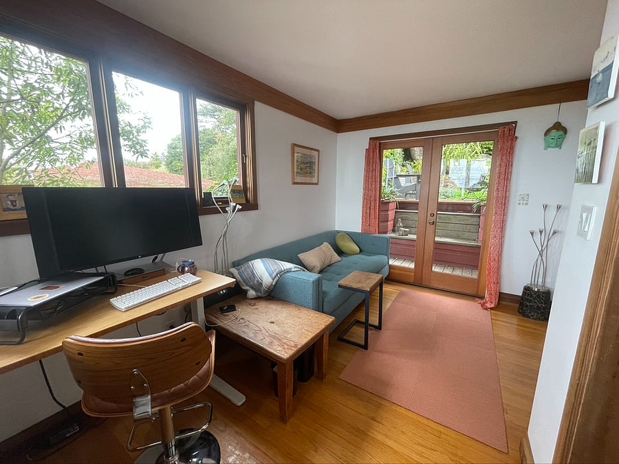 1st floor office with comfortable queen pullout sofa and two work desks, one adjustable height