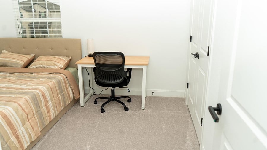 Bedroom 2- bed, desk, chair, closet and lamp
