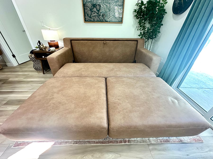 Living room queen sleeper sofa bed for guests (seat opens forward, back of the couch comes down, cushions can be put back in place or left off). Full set of sheets, comforter+cover and pillows are ready in the unit.