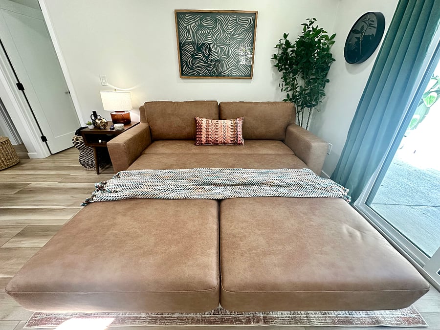 Living room queen sleeper sofa bed for guests (seat opens forward, back of the couch comes down, cushions can be put back in place or left off). Full set of sheets, comforter+cover and pillows are ready in the unit.
