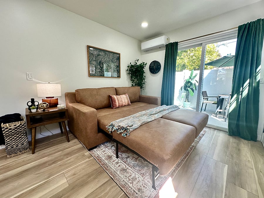 Living room queen sleeper sofa bed for guests (seat opens forward, back of the couch comes down, cushions can be put back in place or left off). Full set of sheets, comforter+cover and pillows are ready in the unit.
