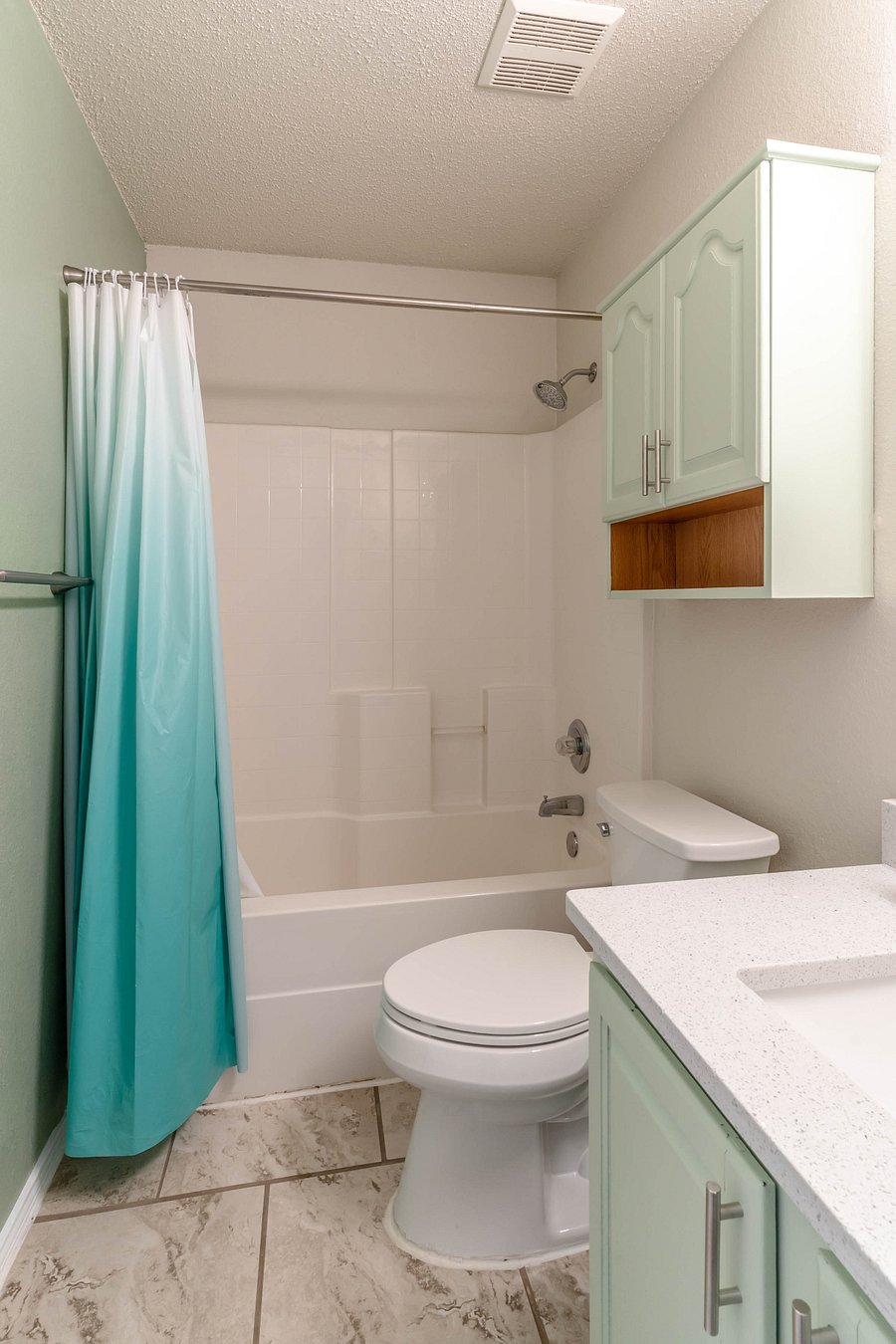 Hallway Guest Bathroom with Shower, Tub, Granite counter, and stone floors.