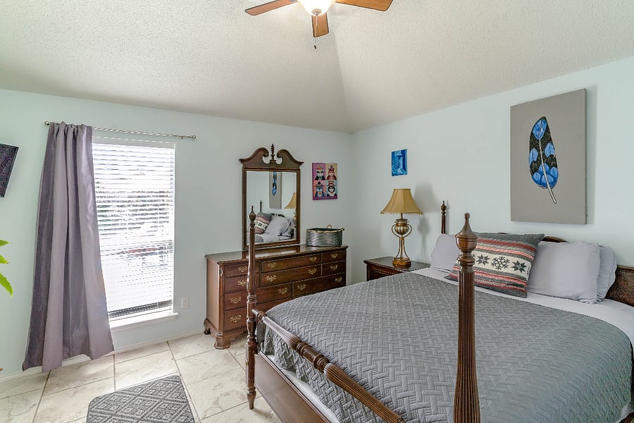 2 of 4 Bedrooms:  Queen Bed, and view of pool area.