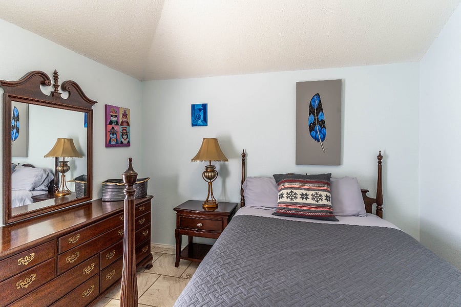2 of 4 Bedrooms:  Queen Bed, and view of pool area.