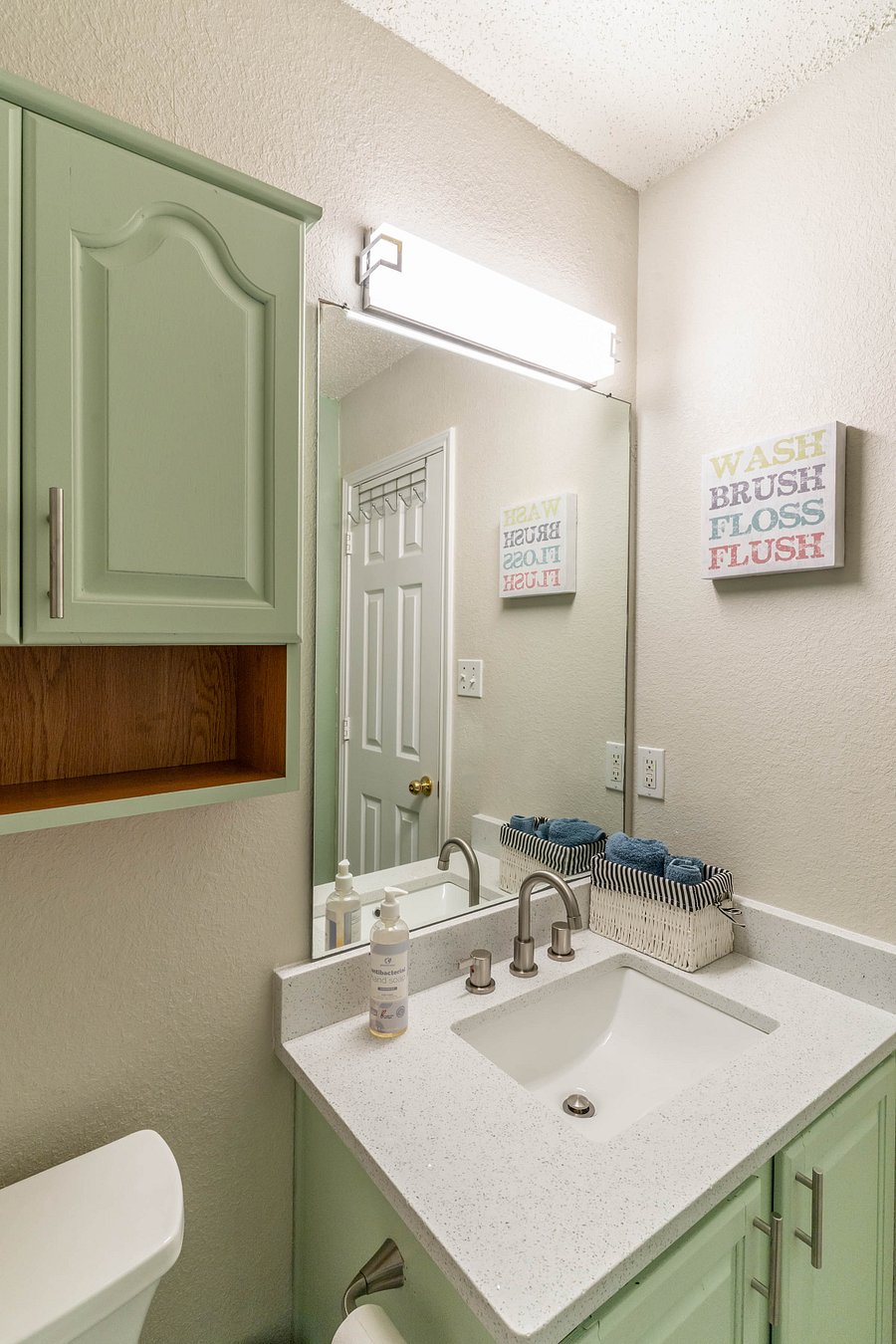 Hallway Guest Bathroom with Shower, Tub, Granite counter, and stone floors.
