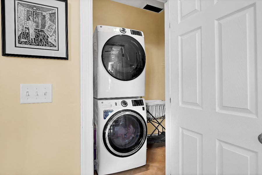 full size washer dryer with laundry chute from primary bedroom