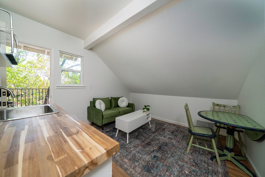 Living room and kitchenette with access to private deck.