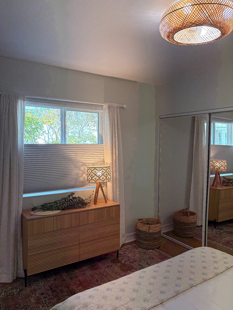 full dresser, macrame lamp, and live eucalyptus. window looks over private backyard
