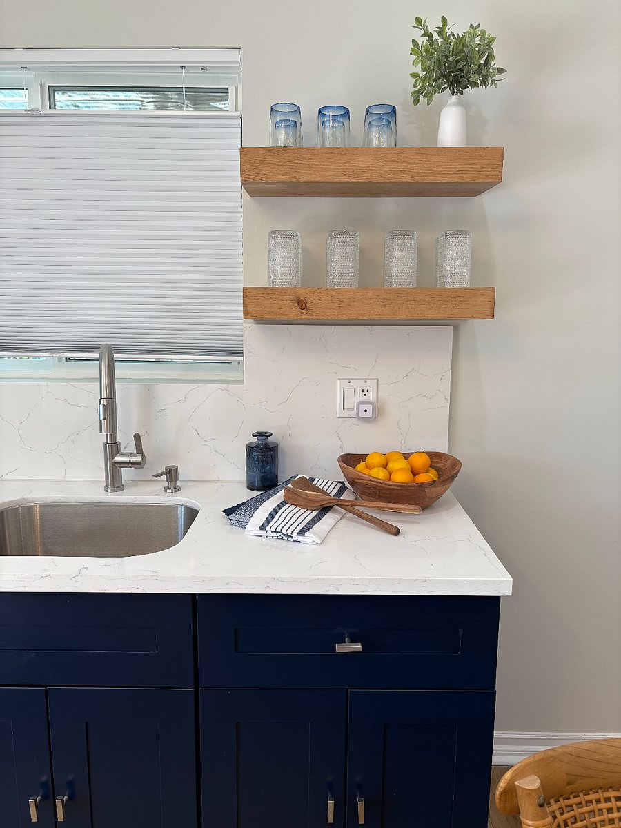floating shelves, beautiful glassware, deep sink, quartzite backsplash and countertop