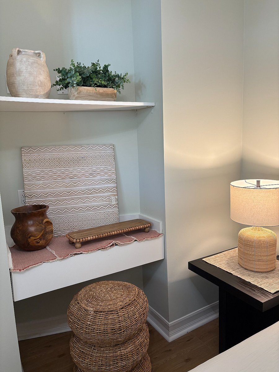 inviting nook with desk, drawer, and wicker stool in the bedroom