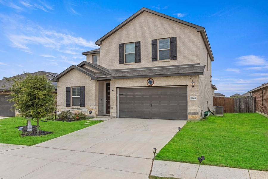 2 car garage with additional parking on the driveway