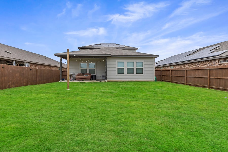Fully fenced backyard with turf