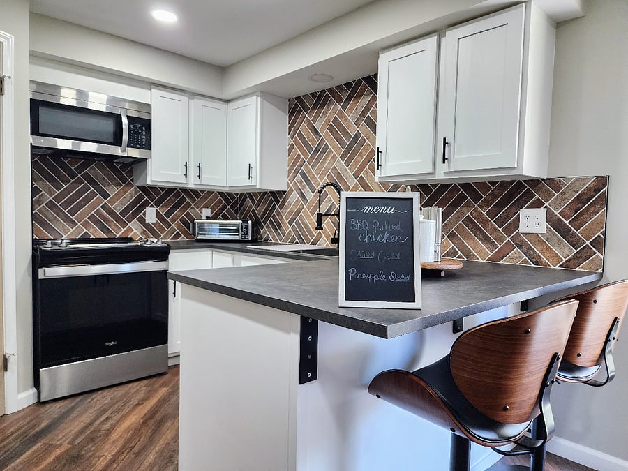 modern newly renovated kitchen with all stainless steel appliances, island seating for casual eating