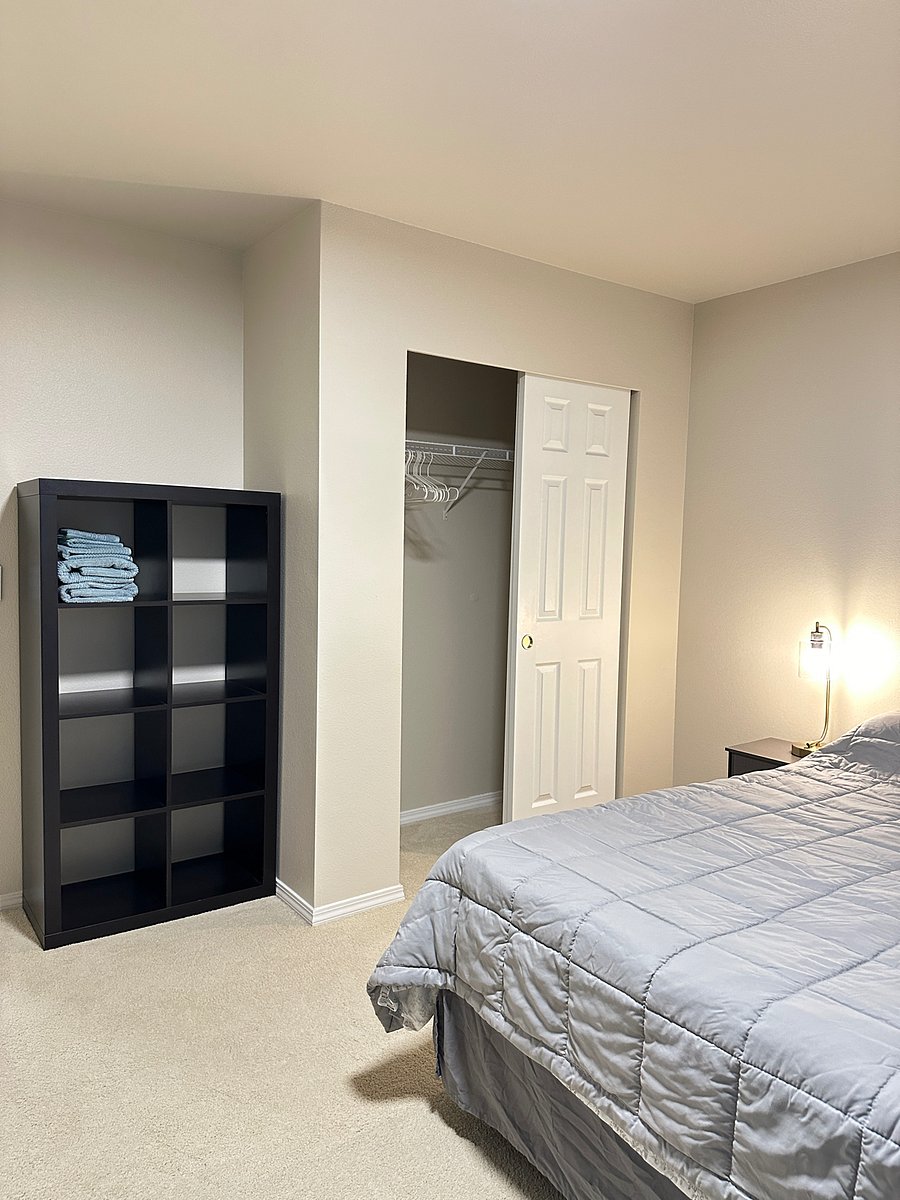 large closet and shelf makes for a lot of storage space