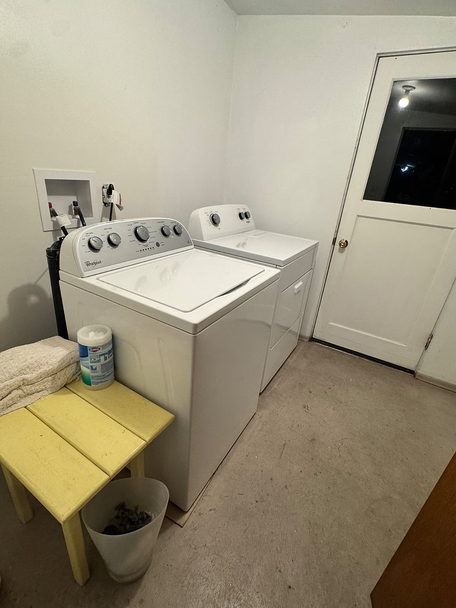 Common area laundry next to unit, free to use, shared by 2 other long term tenants.
