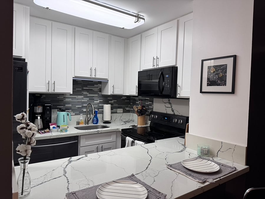 Kitchen with eat in counter and bar stools