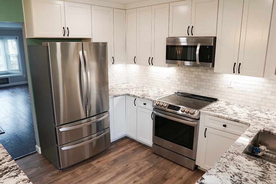 newly renovated kitchen with all new flooring, cabinets, countertops, lighting, and appliances
