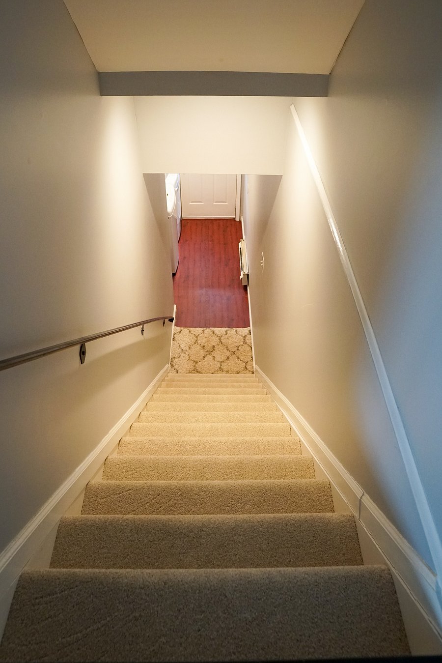 downstairs laundry room and walkout, padded flooring, baseboard electric heater