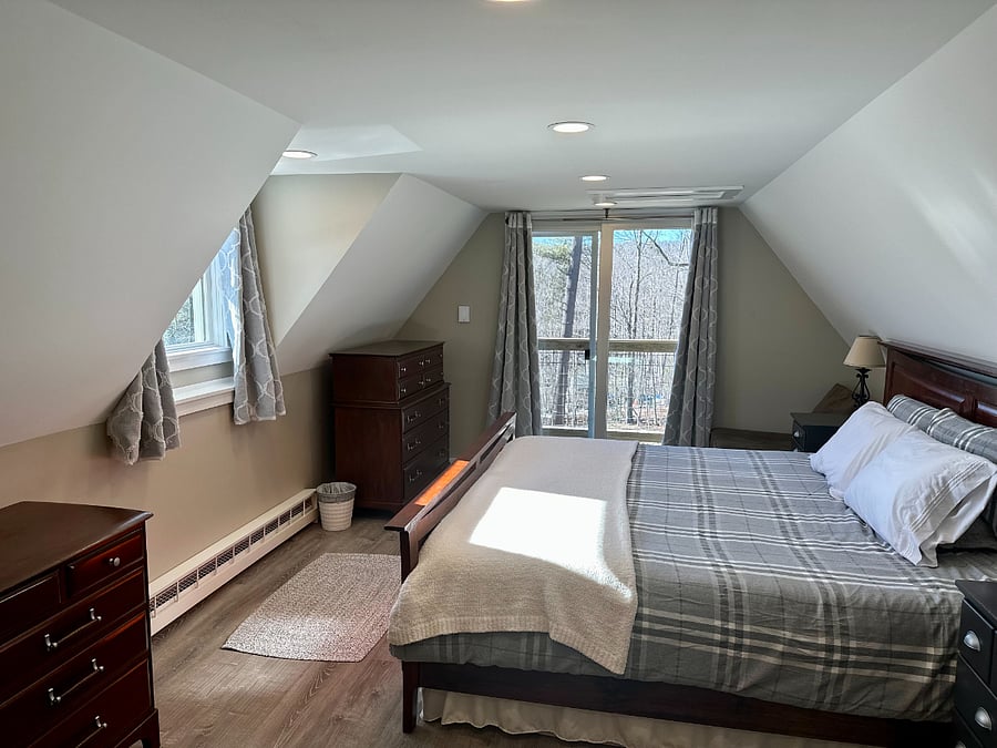 Secod floor bedroom with sliding glass door to small deck. Winter views of Mount Snow.