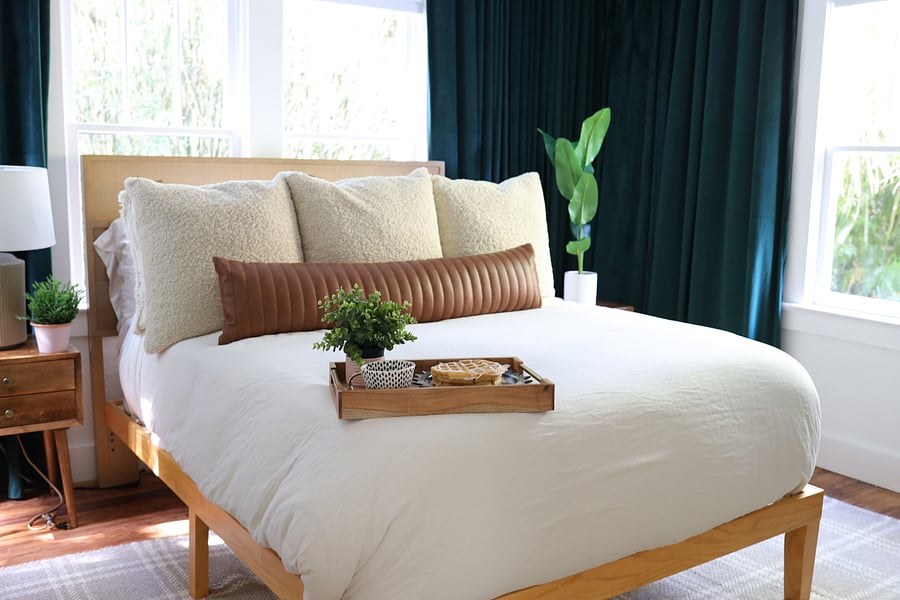 Sleep in ultimate comfort. The primary bedroom features a plush queen bed, luxurious sheets, and blackout curtains for the perfect nights rest