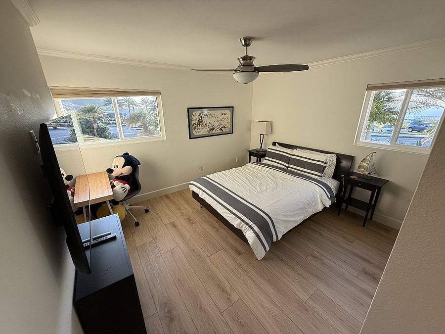Strands bedroom furnished with a remote work desk and smart TV