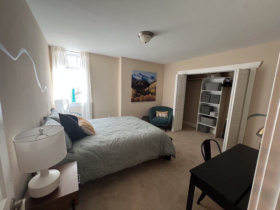 Bedroom with queen bed, large closet, fan, white-noise machine, blackout curtains and desk