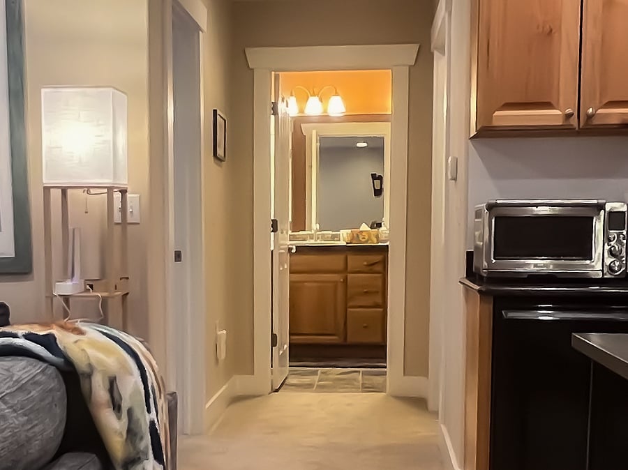Bedroom on the left, dual-sink bathroom, laundry room is on the right