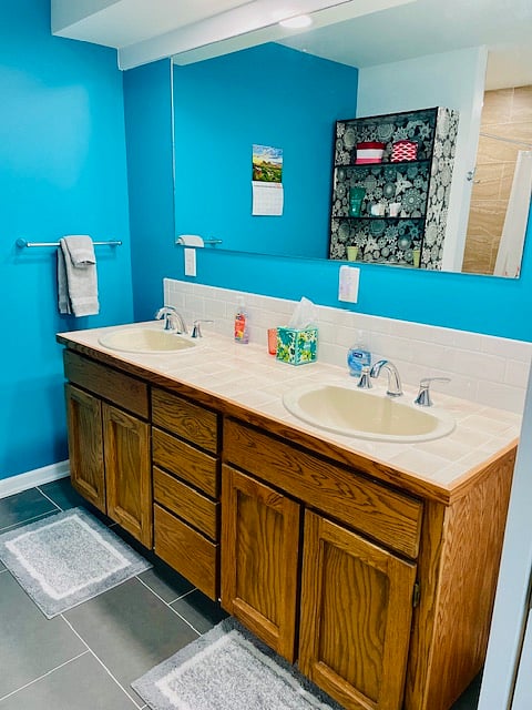 Double vanity with several drawers. Shelves with extra towels and hygiene supplies provided. Blow dryer provided.
