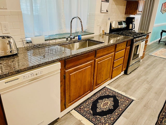 Sink and stove area in front of window.
