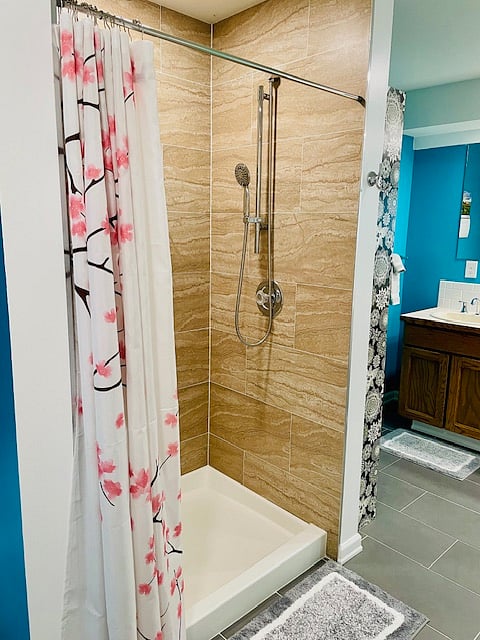 Adjustable shower head in shower.