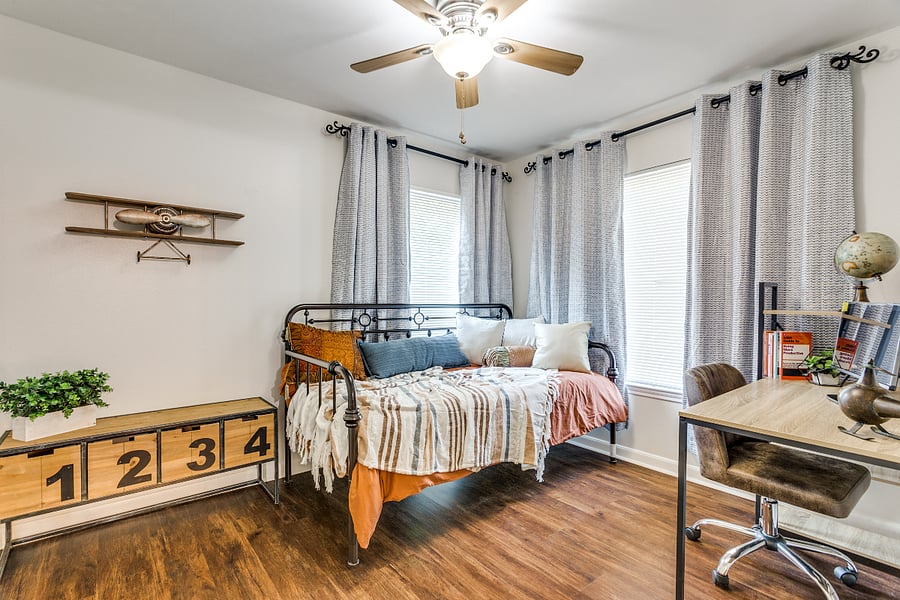 large closet, daybed, workstation with additional screen and bookshelves, blackout curtains, adequate space for hanging and folded clothes
