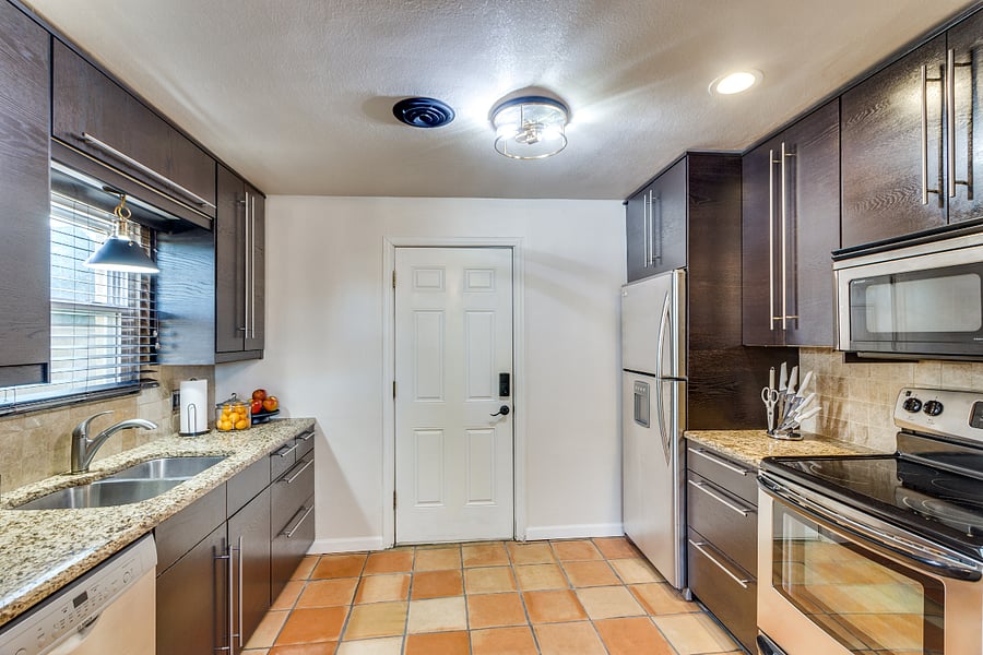 fully stocked kitchen, coffee pot, plenty of storage space, kitchen leads to fenced in back yard with additional parking and dog run