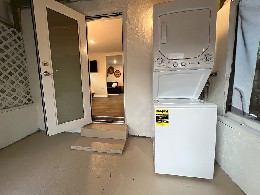 Stacked washer/dryer located on covered porch