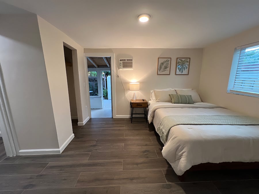 Bedroom door opens up to porch and garden