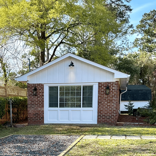 Front view of cottage and designated parking spot.