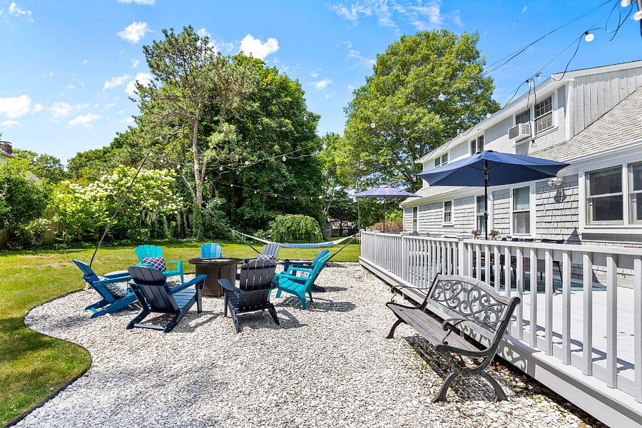 Gas firepit with Adirondack chairs.