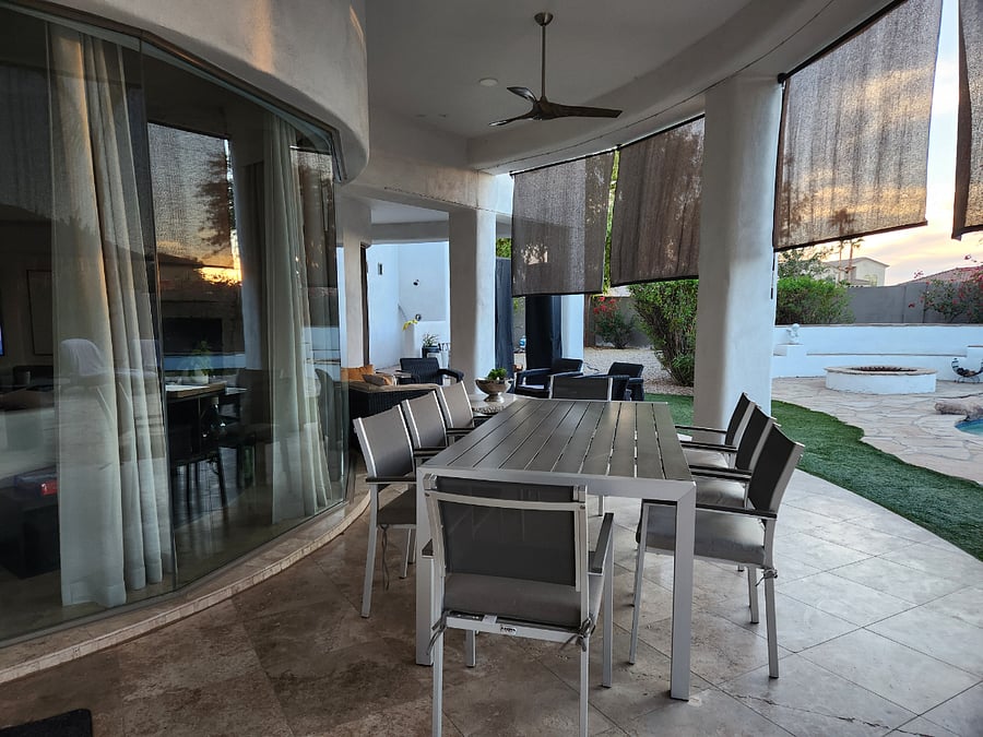 Covered patio with dining table and sitting area