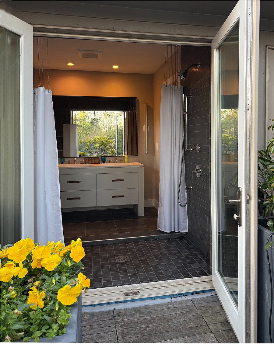 Indoor/outdoor shower arrangement