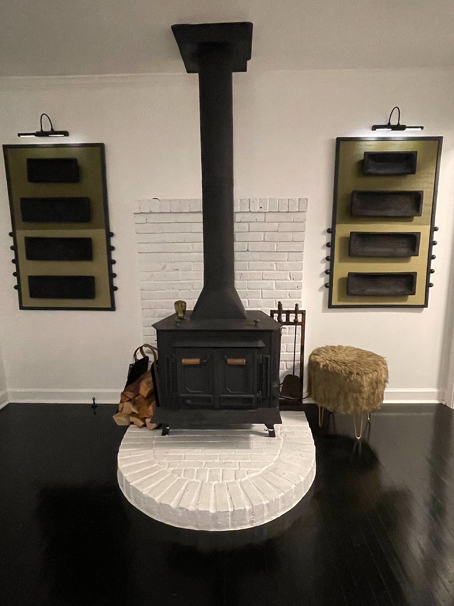 Wood burning stove flanked by custom artwork