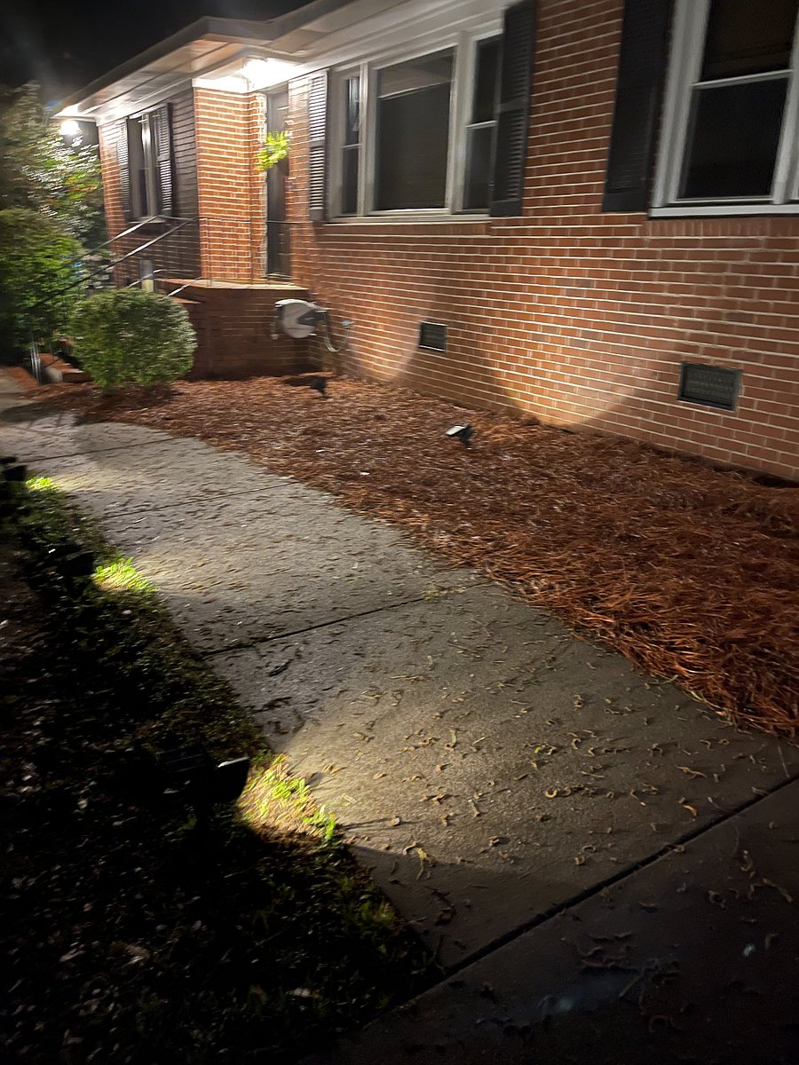 Well lit exterior with landscape lighting at night