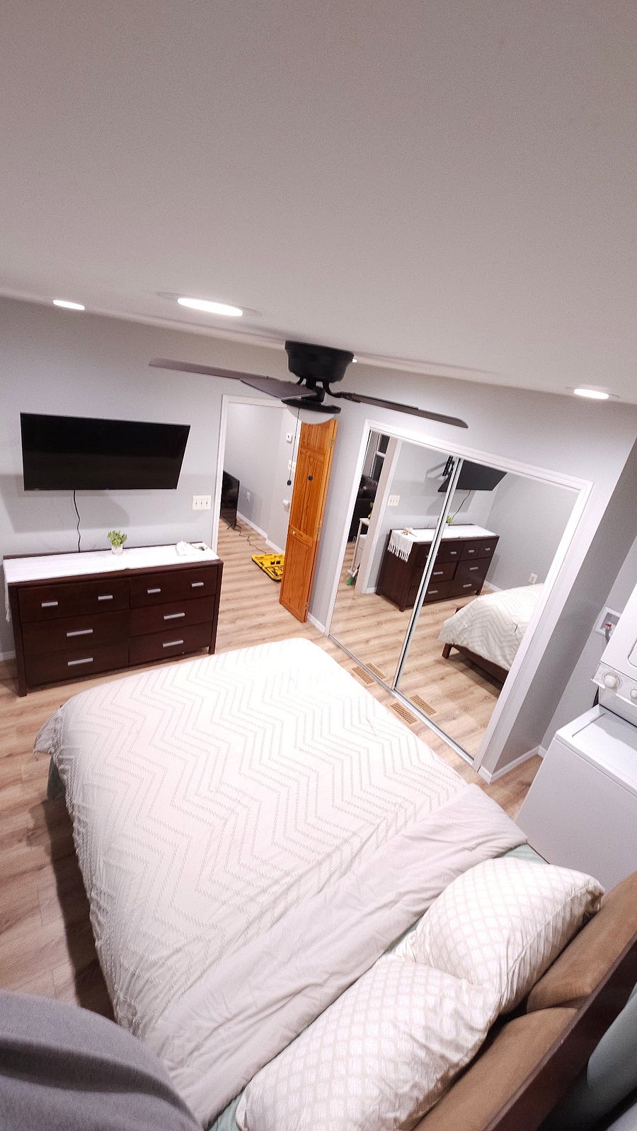 Bedroom dresser, smart TV and double closet with mirror doors