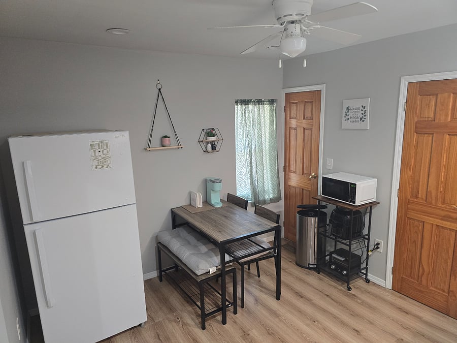 Kitchen and dining room area. Pantry closet pictured in top right corner and entrance to bathroom on the right