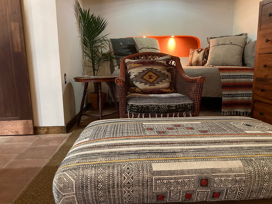 View of trundle bed with illuminated nightstand/niche