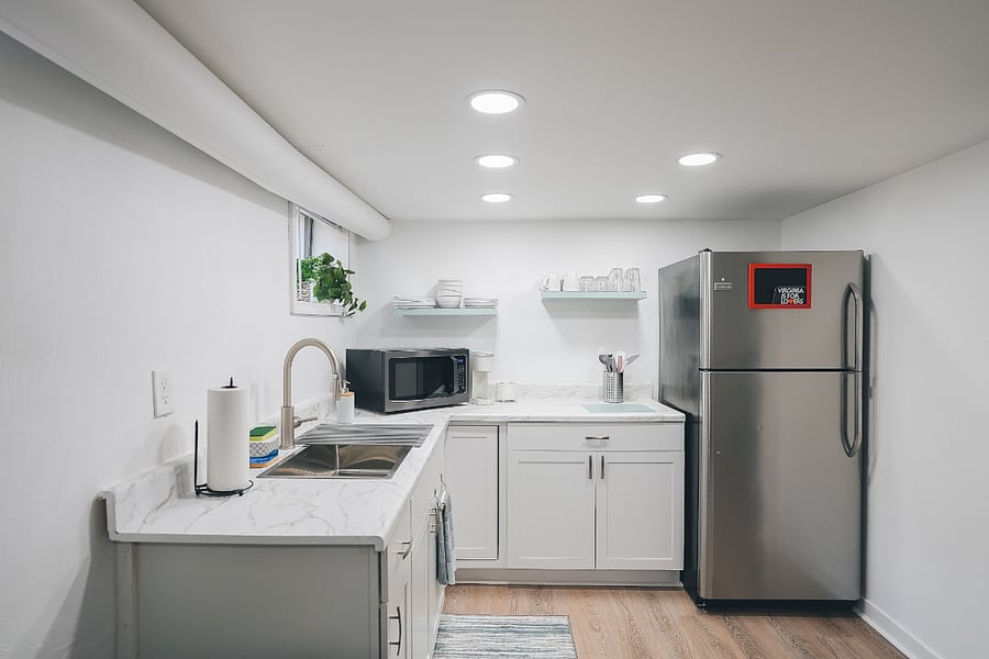 Kitchenette equipped with full-sized fridge, microwave/air fryer, and keurig