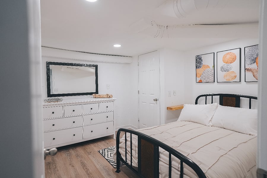 Bedroom with full-sized bed, closet, large dresser, and a closet